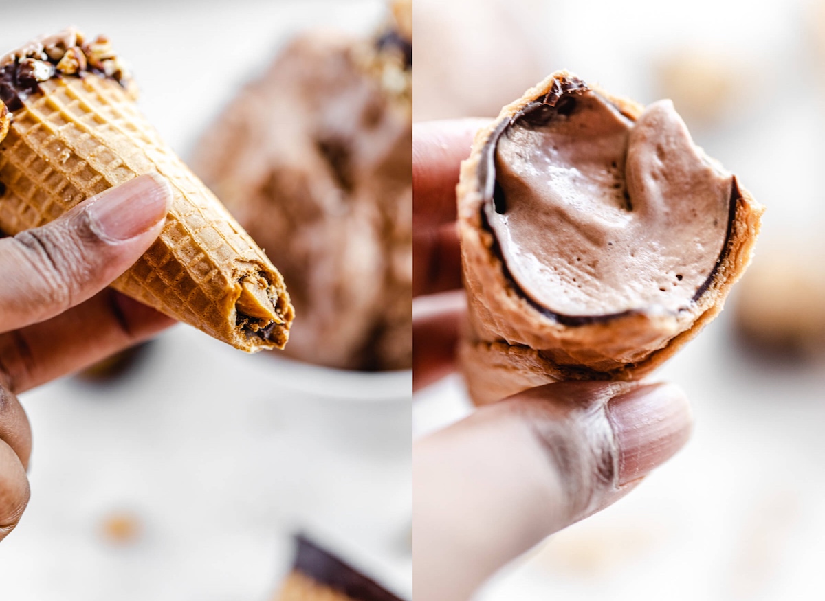 holding half eaten chocolate and peanut butter cones