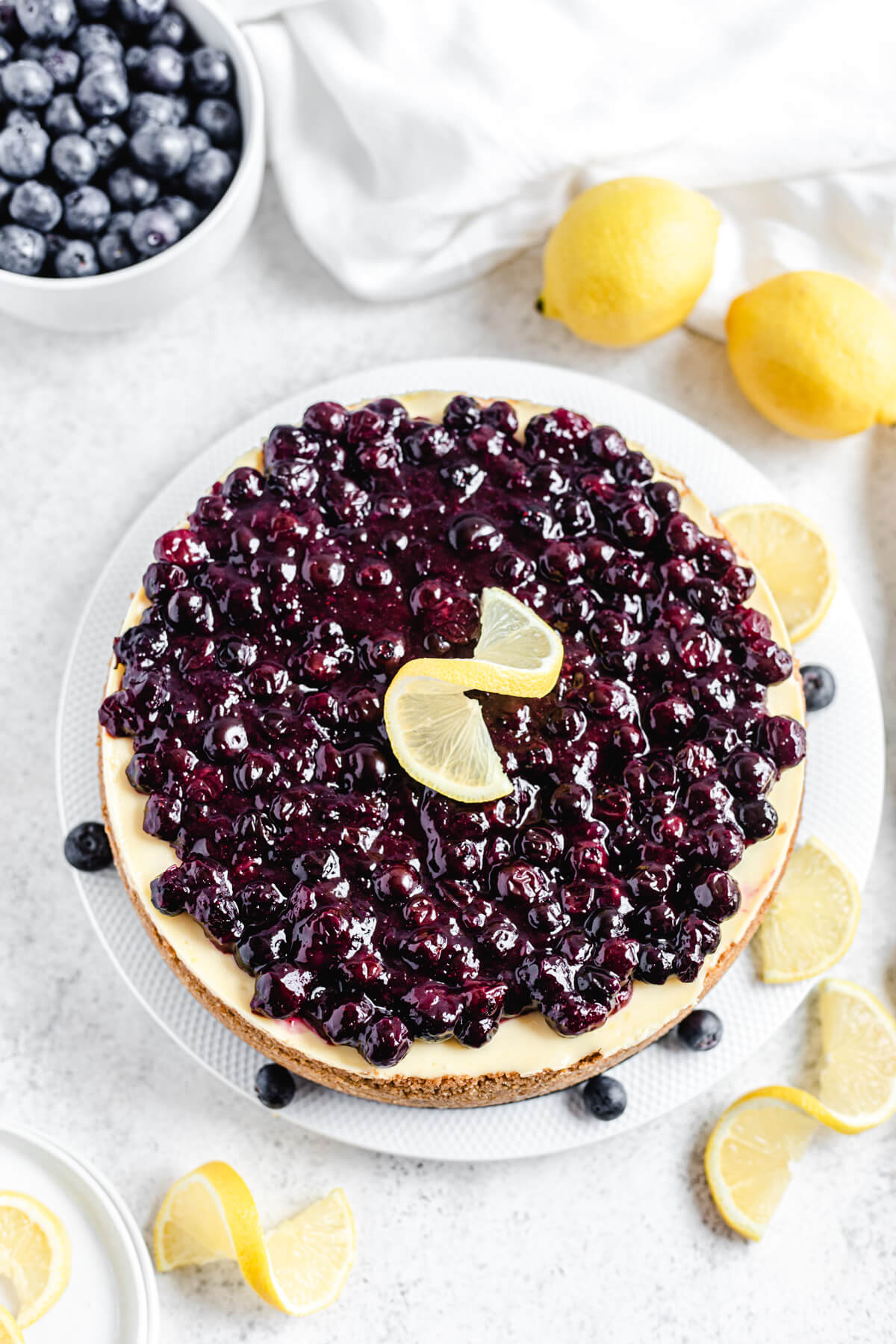 top view of cheesecake topped with blueberries and lemons