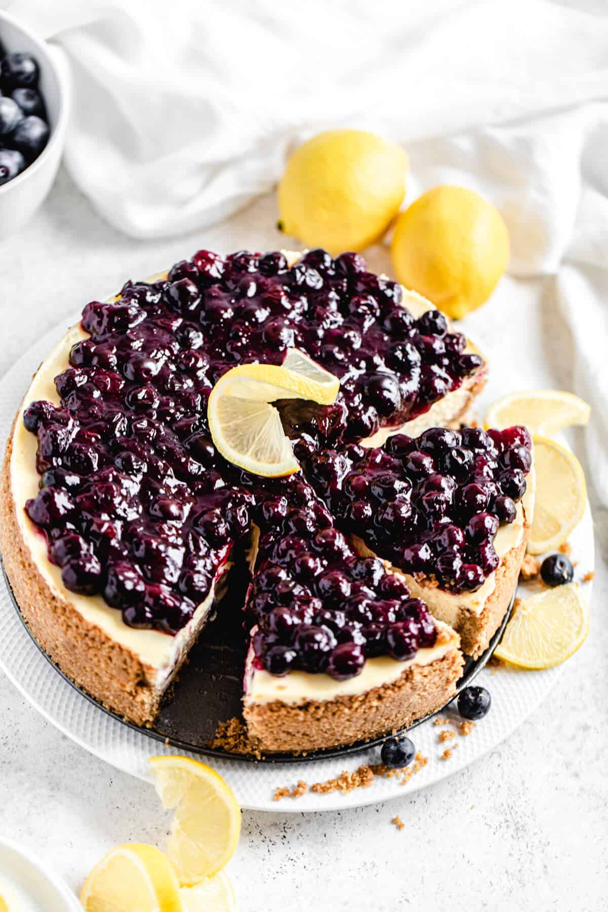 half sliced cheesecake on a white platter