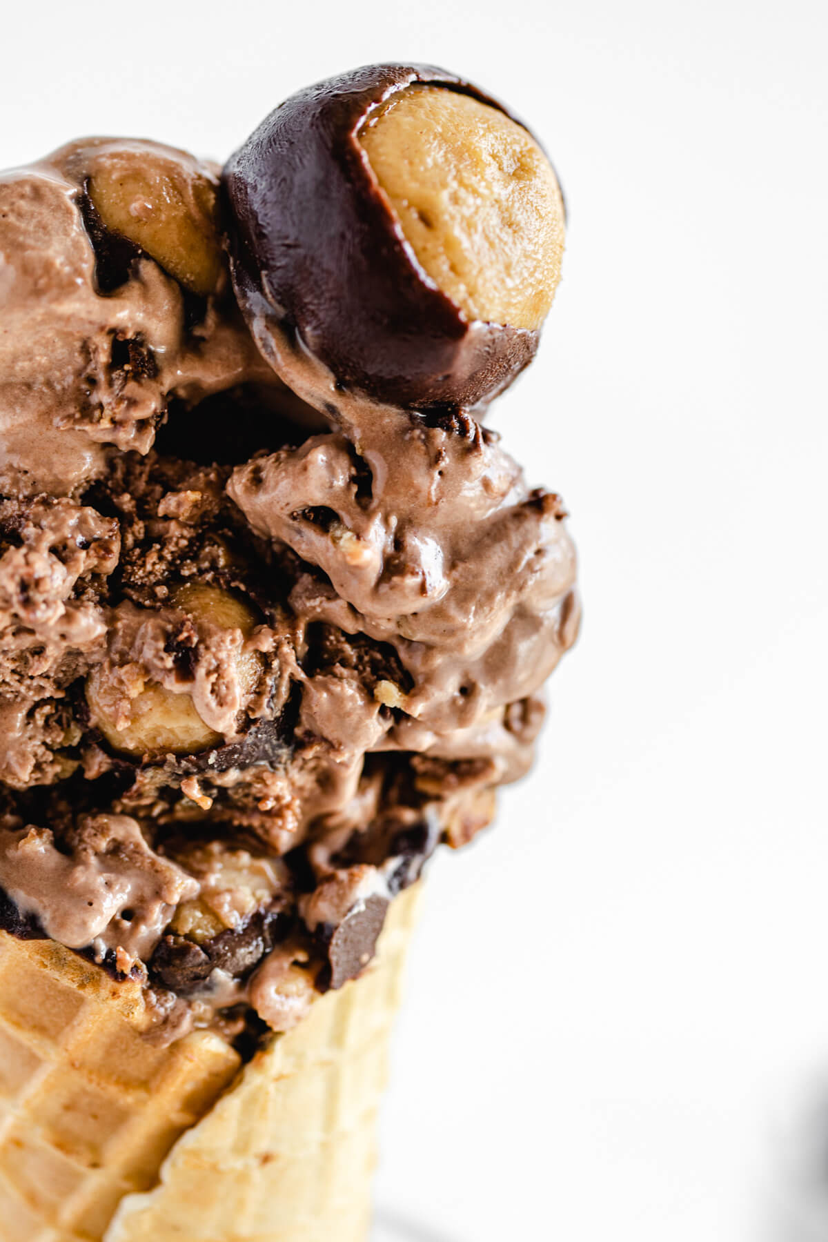 close up of half of an ice cream cone with buckeye truffle on top