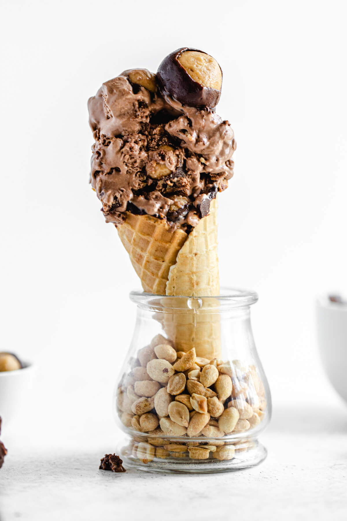 ice cream cone in a glass jar filled with peanuts