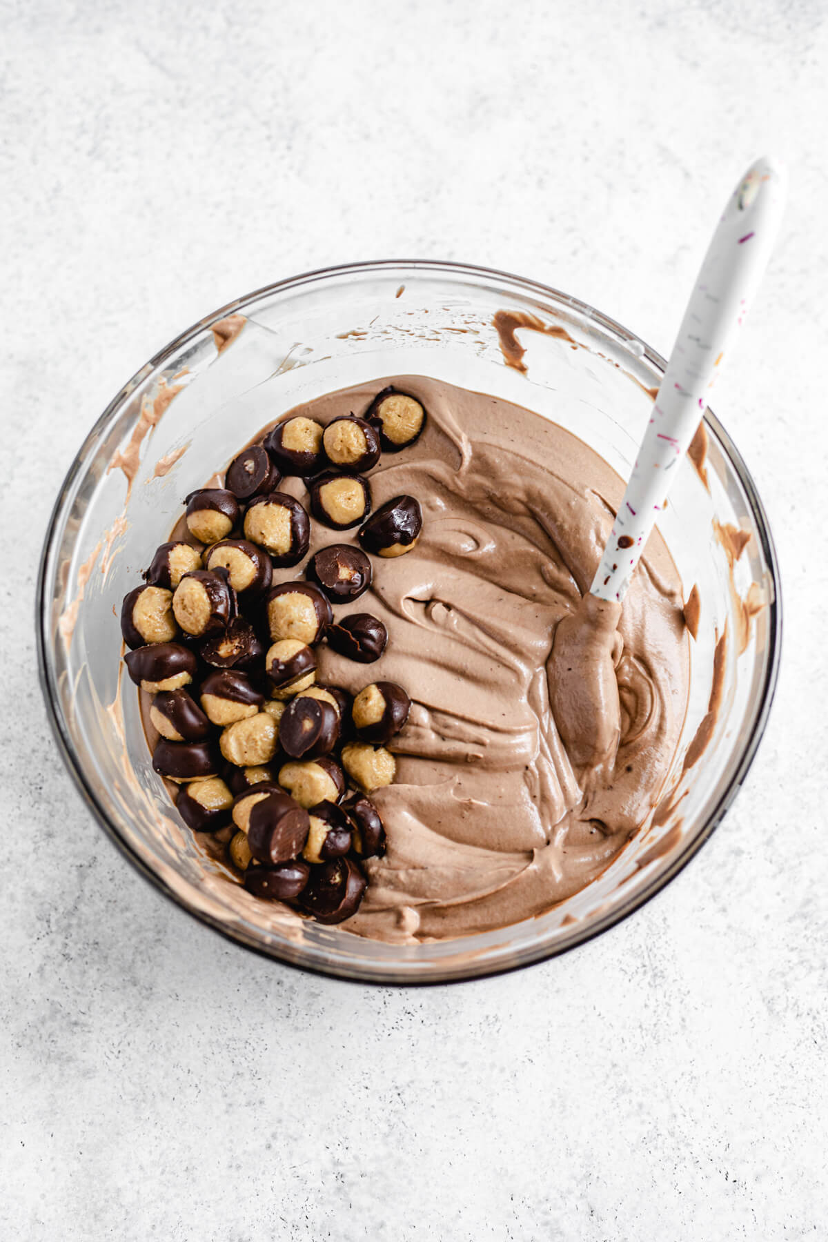 mini buckeye truffles in a bowl of soft chocolate ice cream