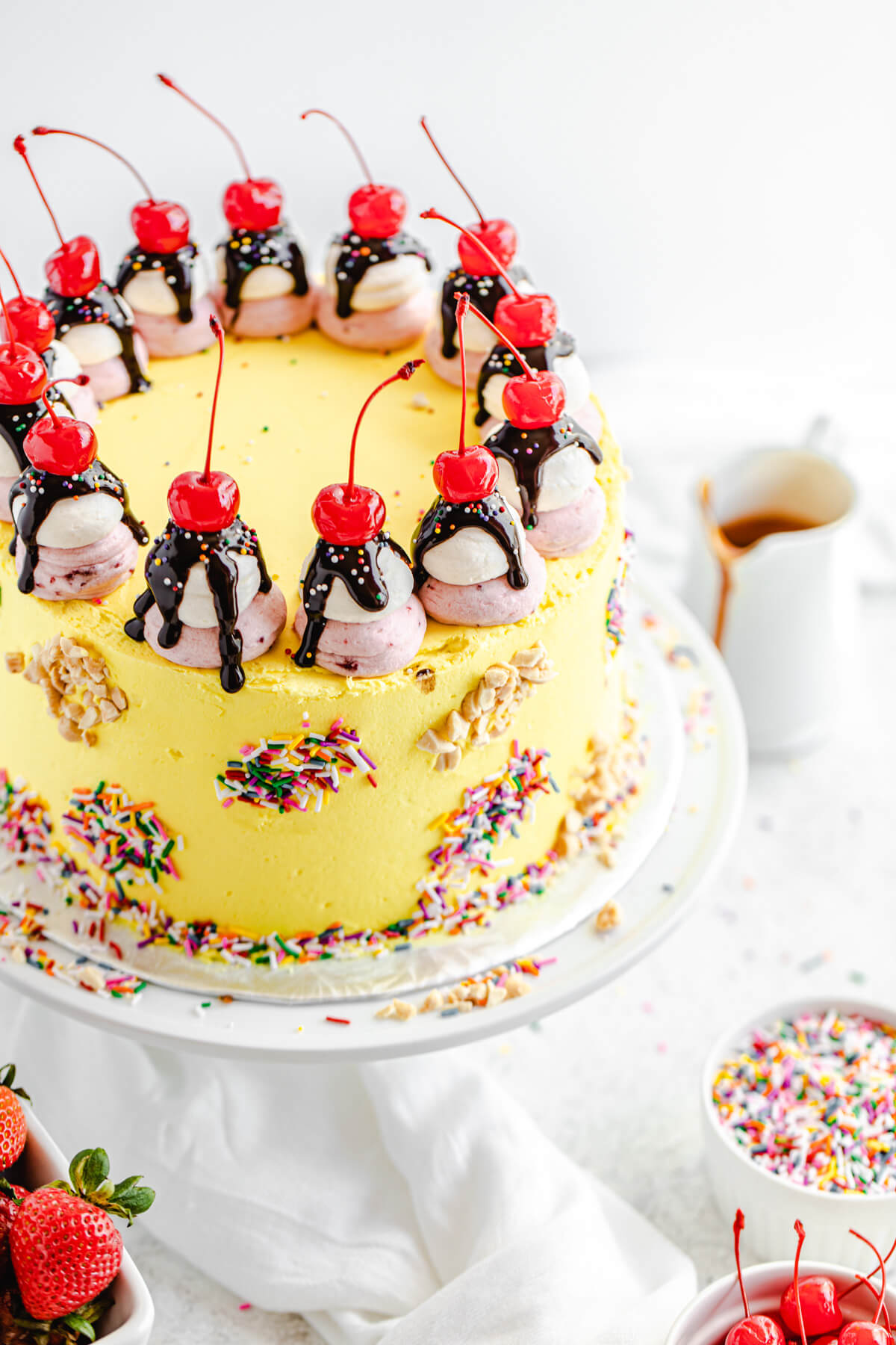 angled view of banana split cake on a cake stand