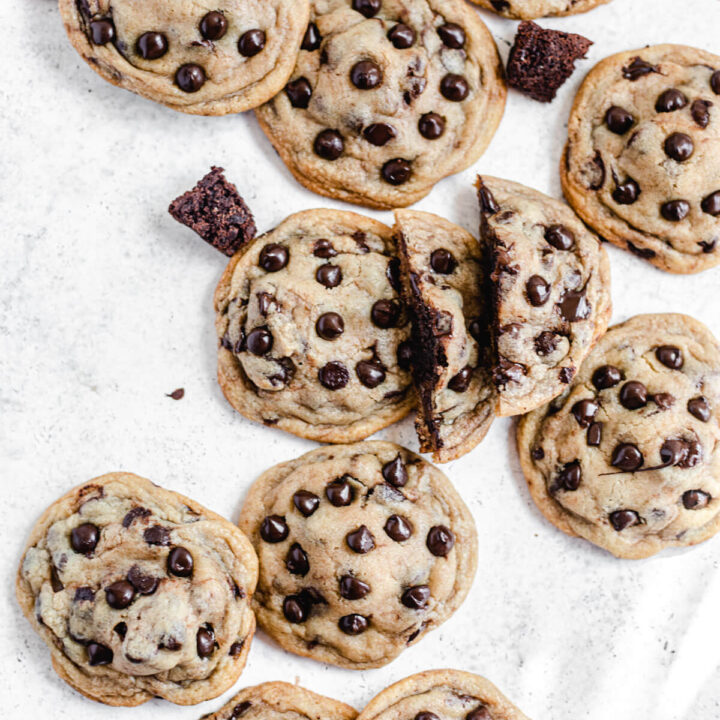 chocolate chip cookies and brownie chunks with one cookie broken in half