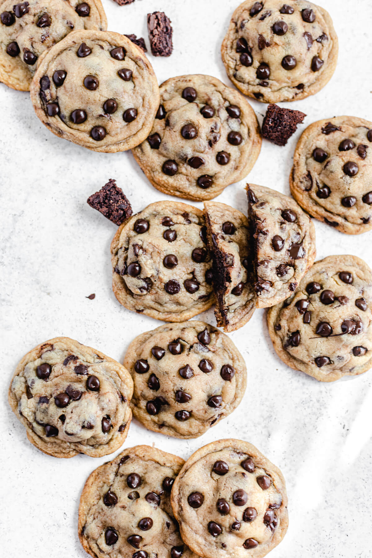 chocolate chip cookies and brownie chunks with one cookie broken in half