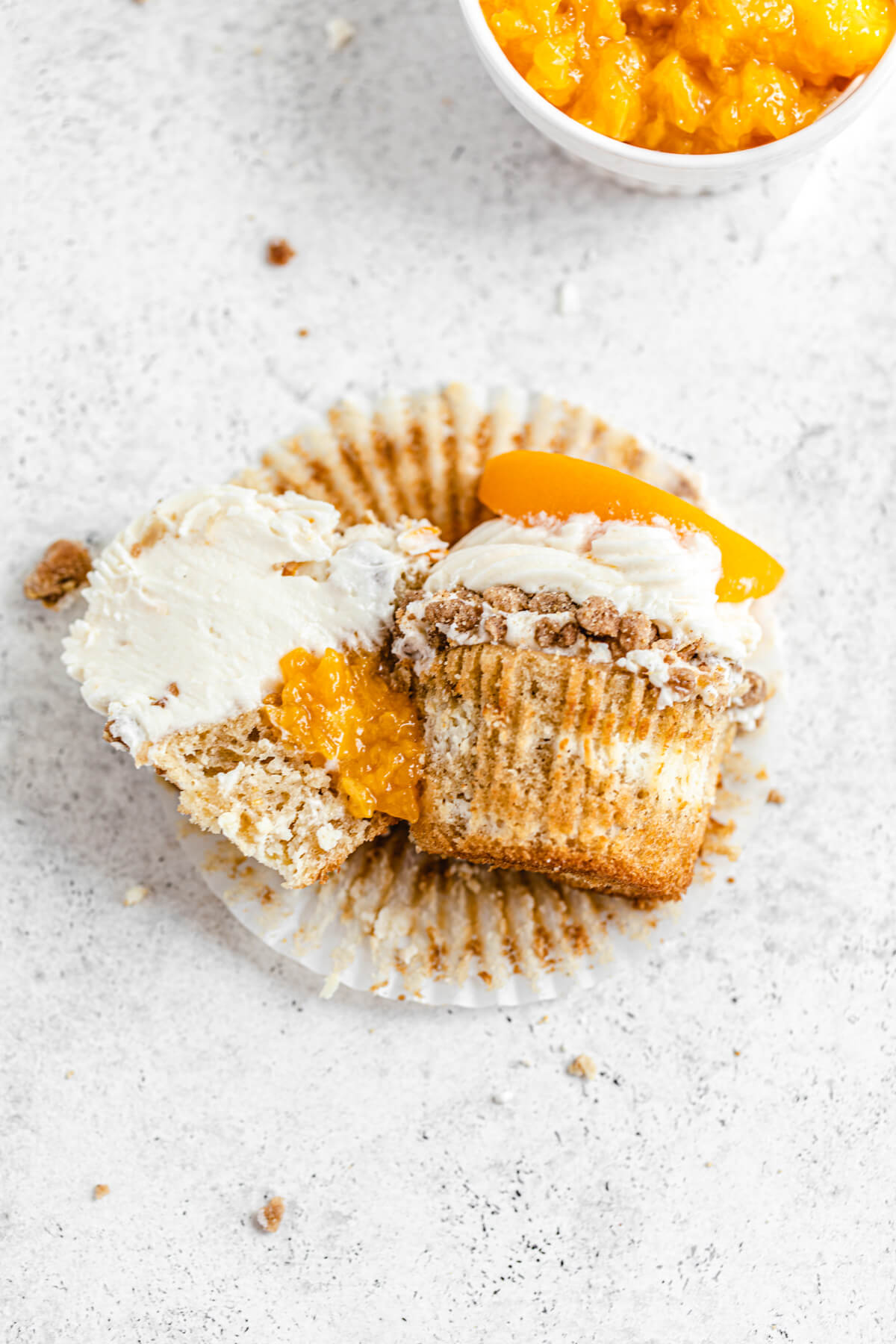 cupcake cut in half with one half facing upward and second half facing backwards slightly leaning on it