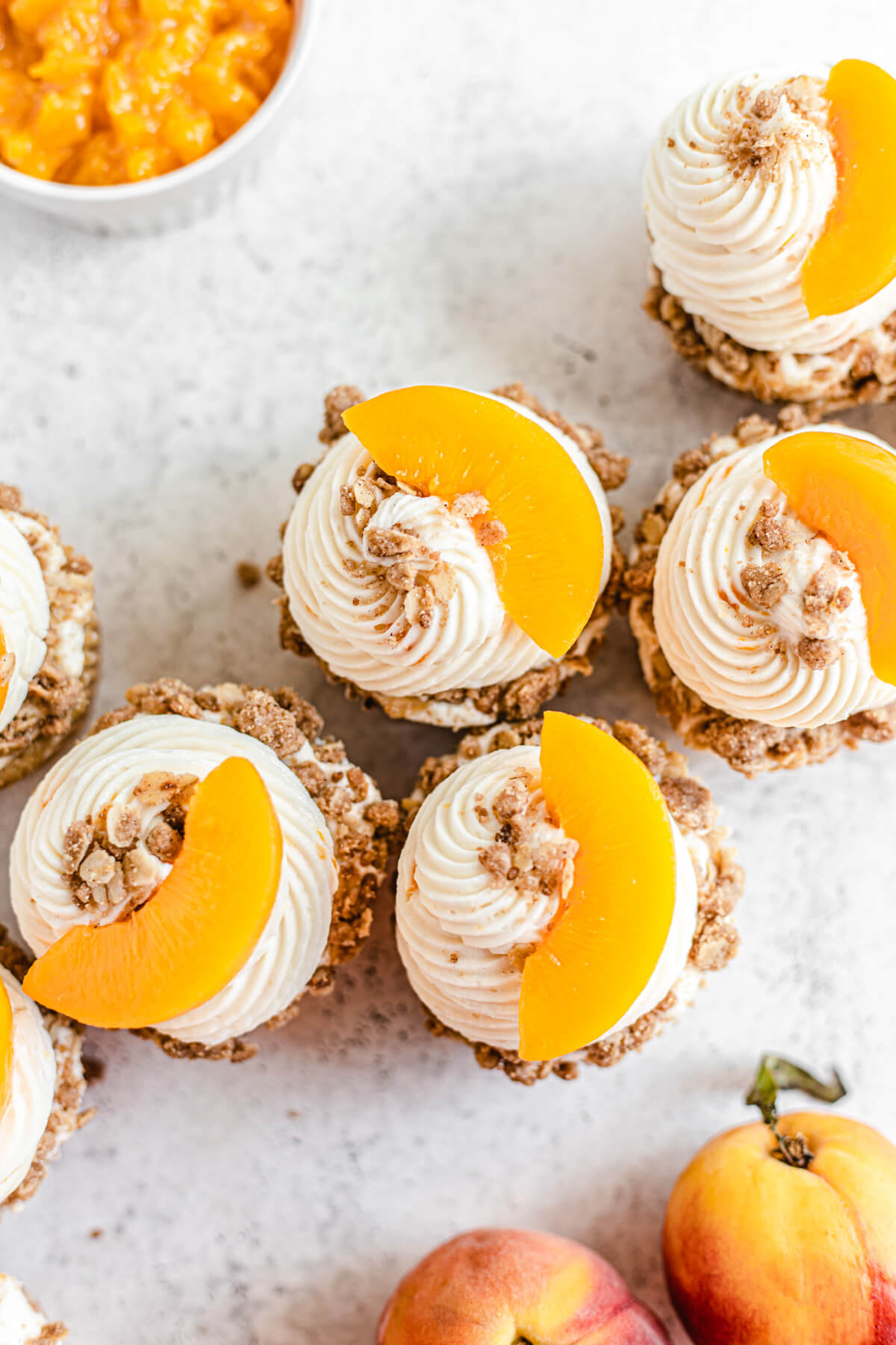 top view of cupcakes topped with crumble and sliced peaches