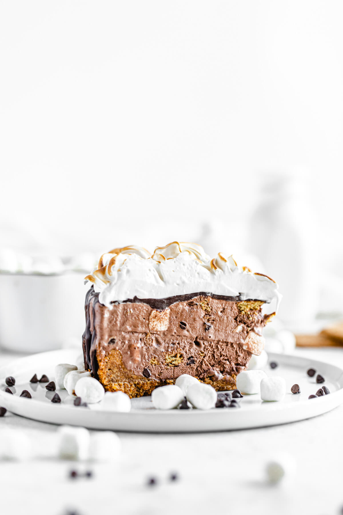 slice of ice cream cake on a white plate decorated with mini marshmallows and chocolate chips