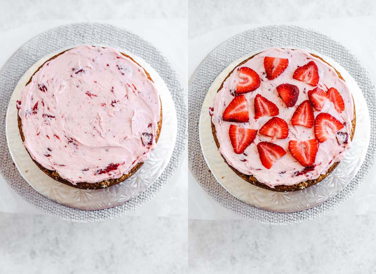strawberry frosting and fresh strawberries on a cake layer