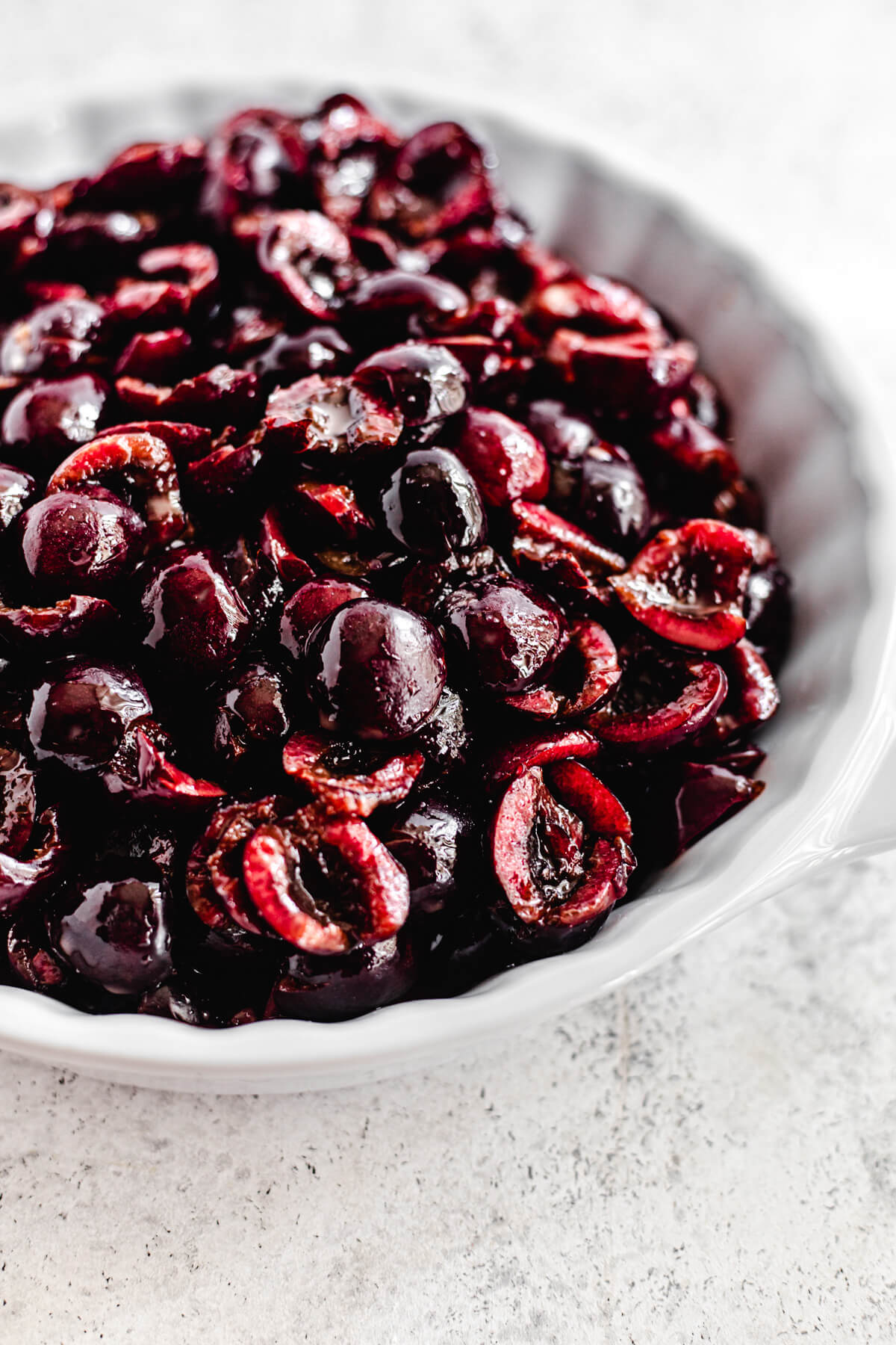 fresh cherry filling in a white pie dish