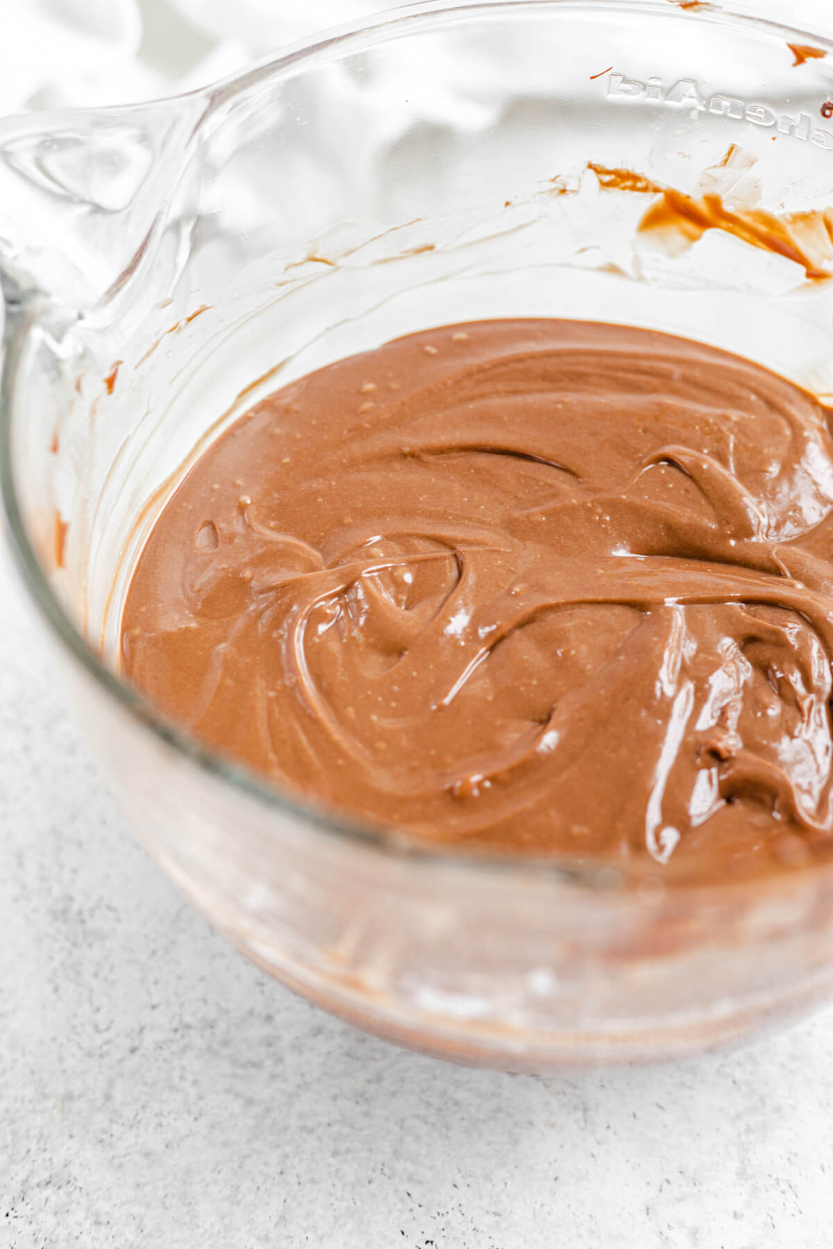 nutella cheesecake batter in a glass mixer bowl