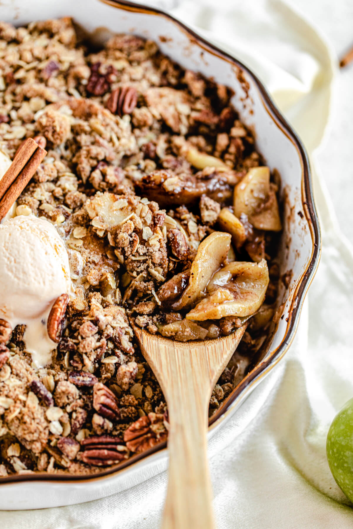 wooden spoon digging into apple crisp