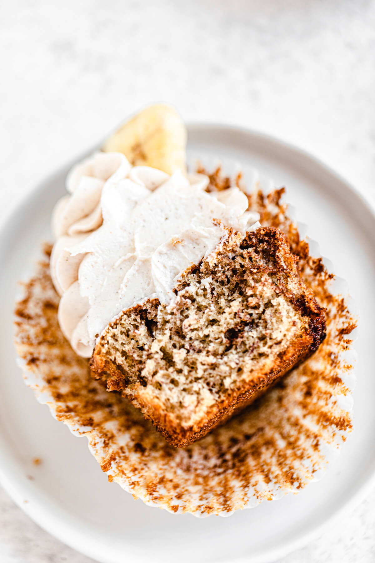 halved cinnamon swirl cupcake laying in a white appetizer plate