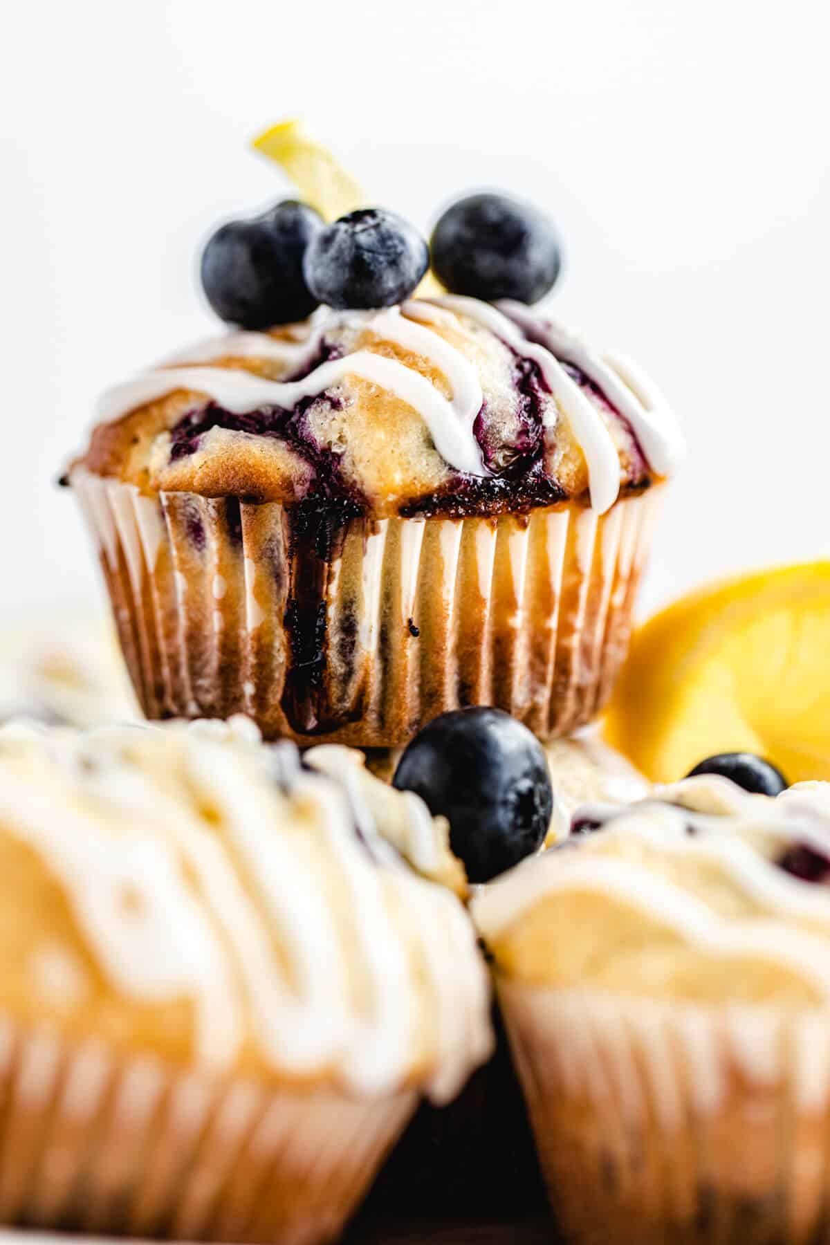 close up of blueberry muffin on top of other muffins