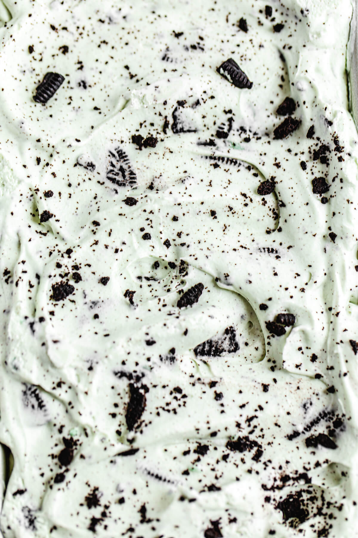 close up of mint ice cream with chopped Oreos inside