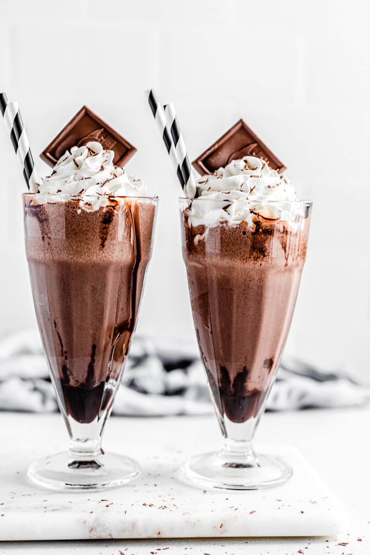 two milkshakes side by side on a marble board