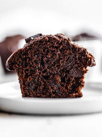 halved muffin on a small white plate