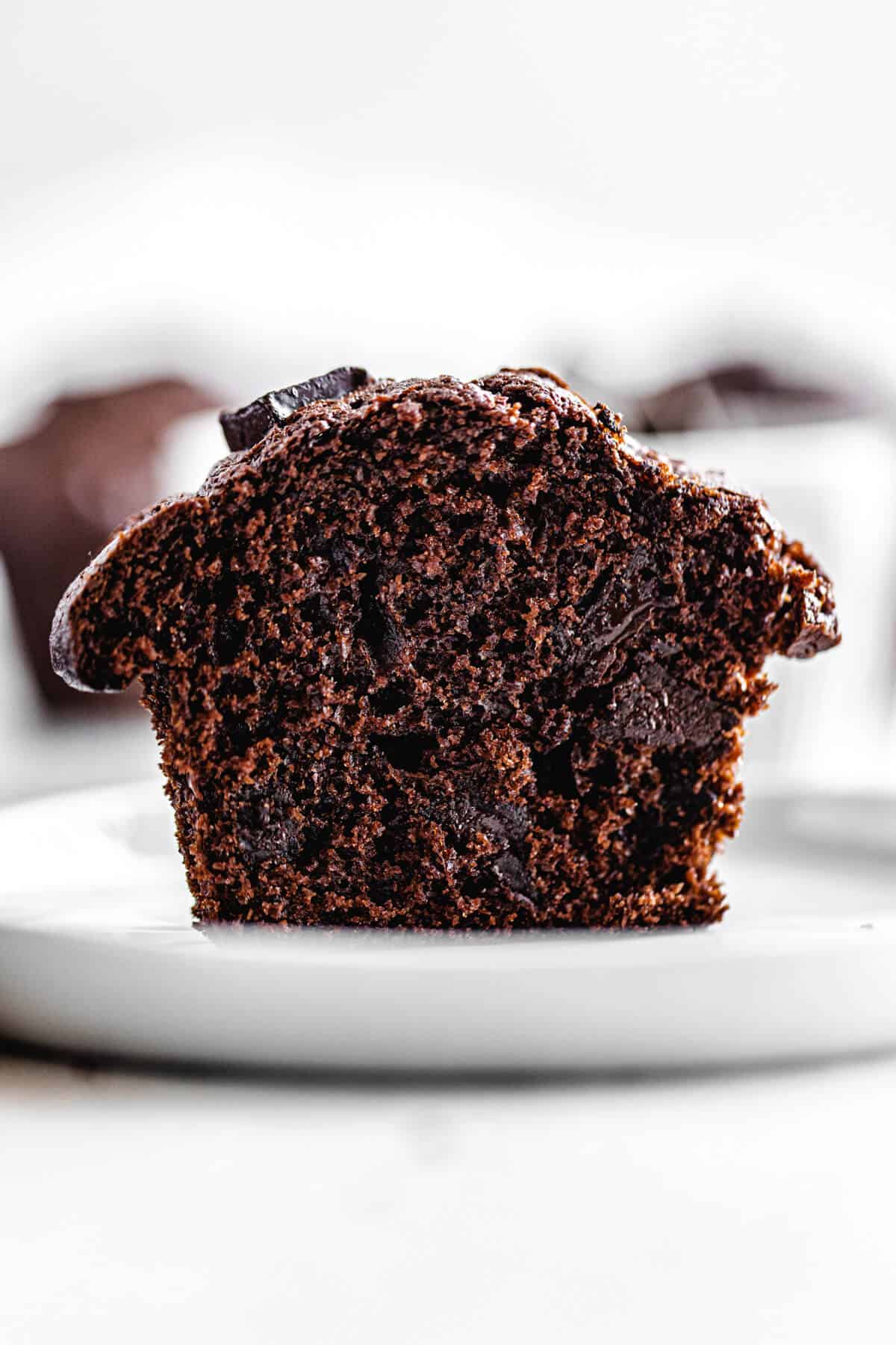 halved muffin on a small white plate