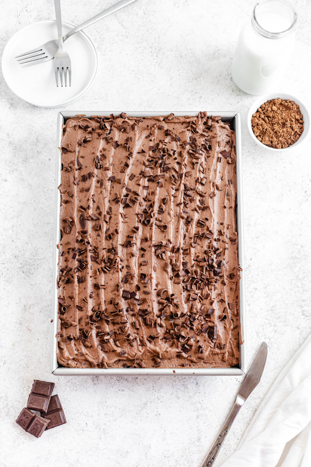 flat-lay of frosted chocolate cake in the rectangle pan 