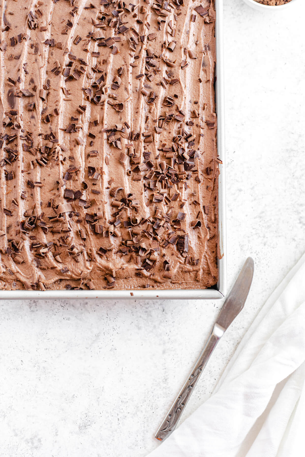 close up of mousse covered cake in a rectangular pan