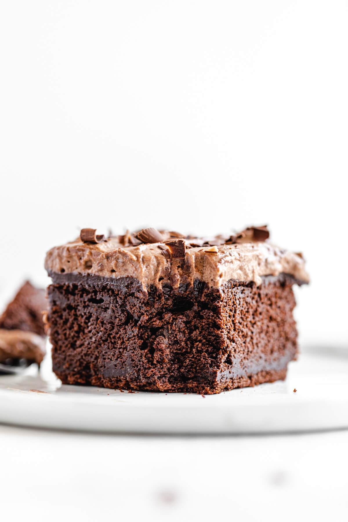 slice of cake with bite removed on a white plate