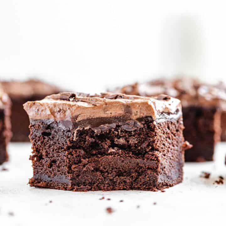 half eaten slice of chocolate cake in the foreground with multiple slices in the background