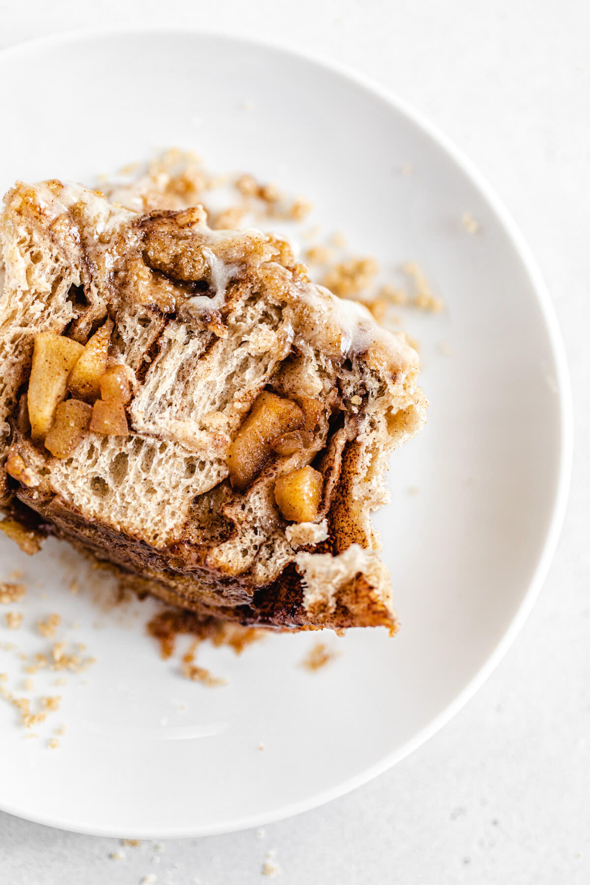 halved cinnamon roll on a white plate