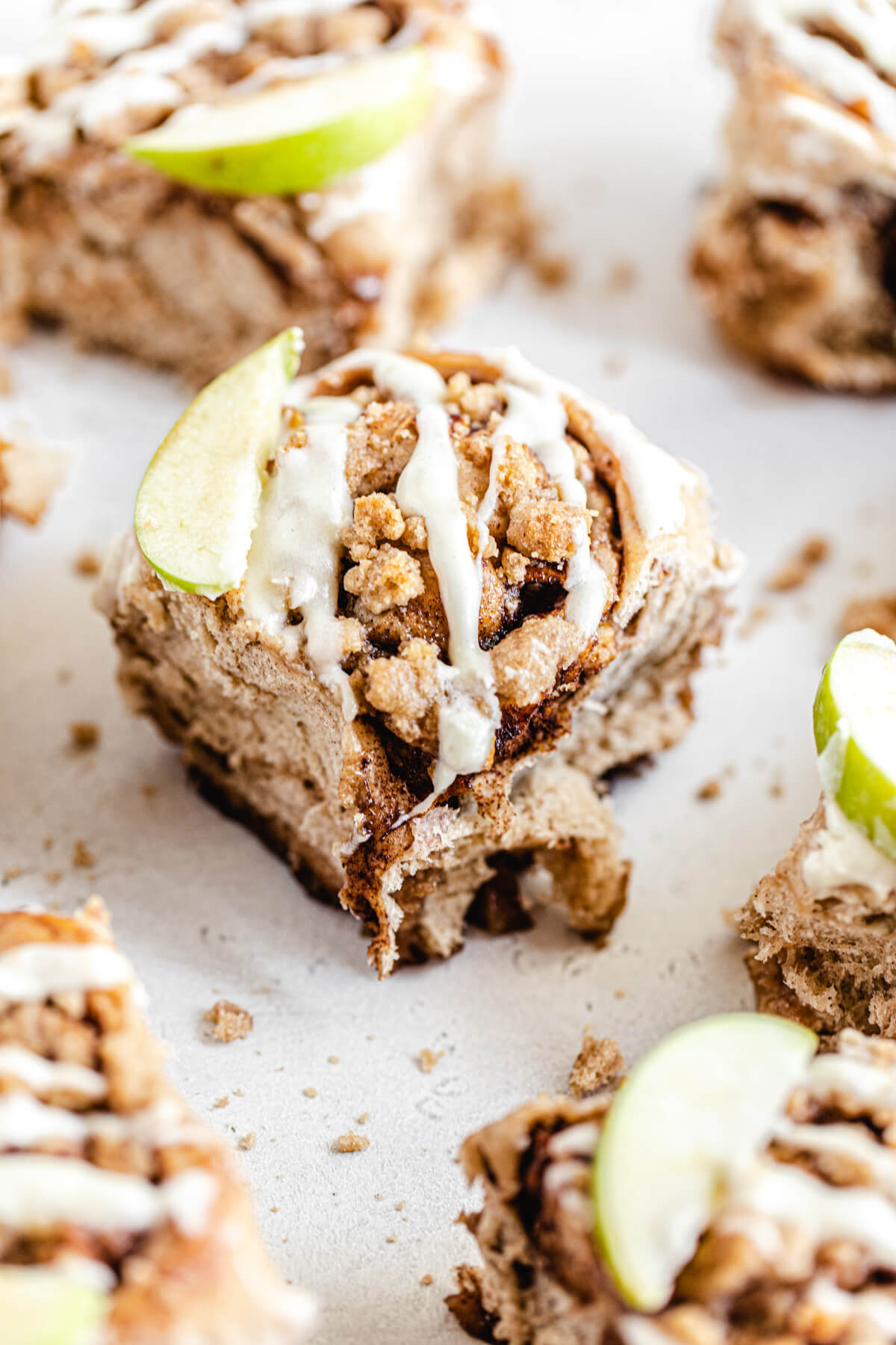 cinnamon rolls topped with apple slices