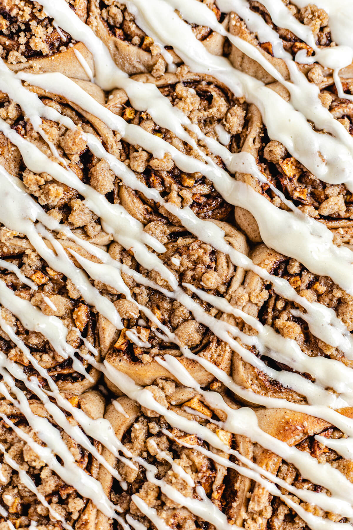 close up of cinnamon rolls with cream cheese drizzle