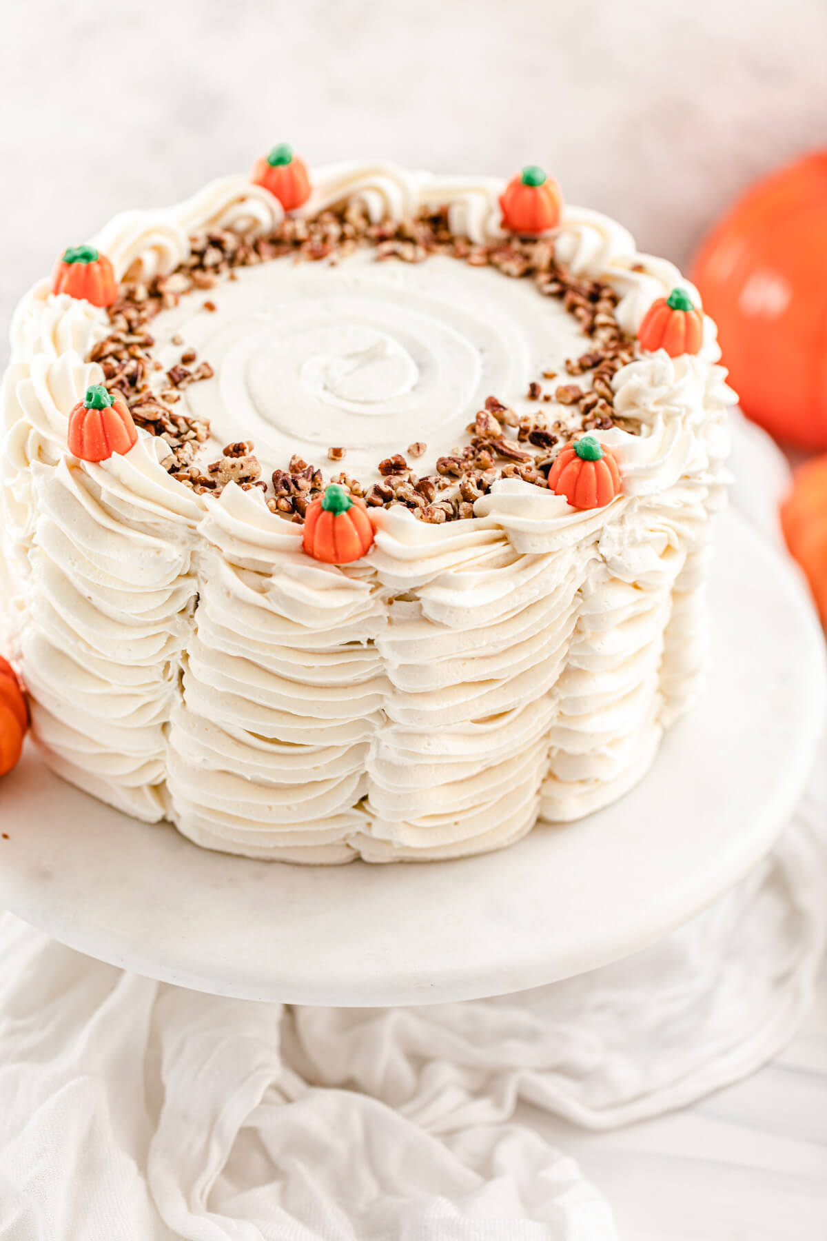 pumpkin candy topped cake on a marble cake stand