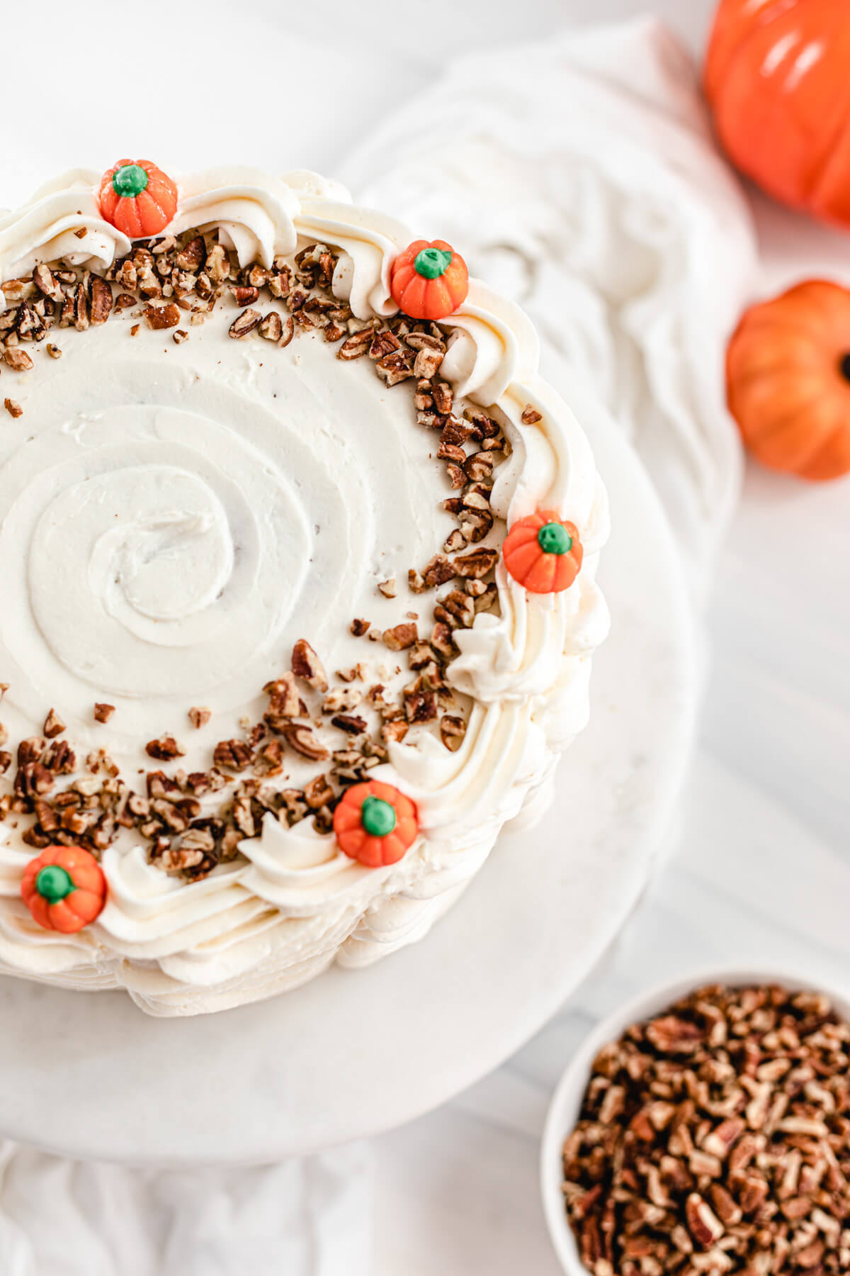 top view of cake decorated with chopped pecans and pumpkin candies