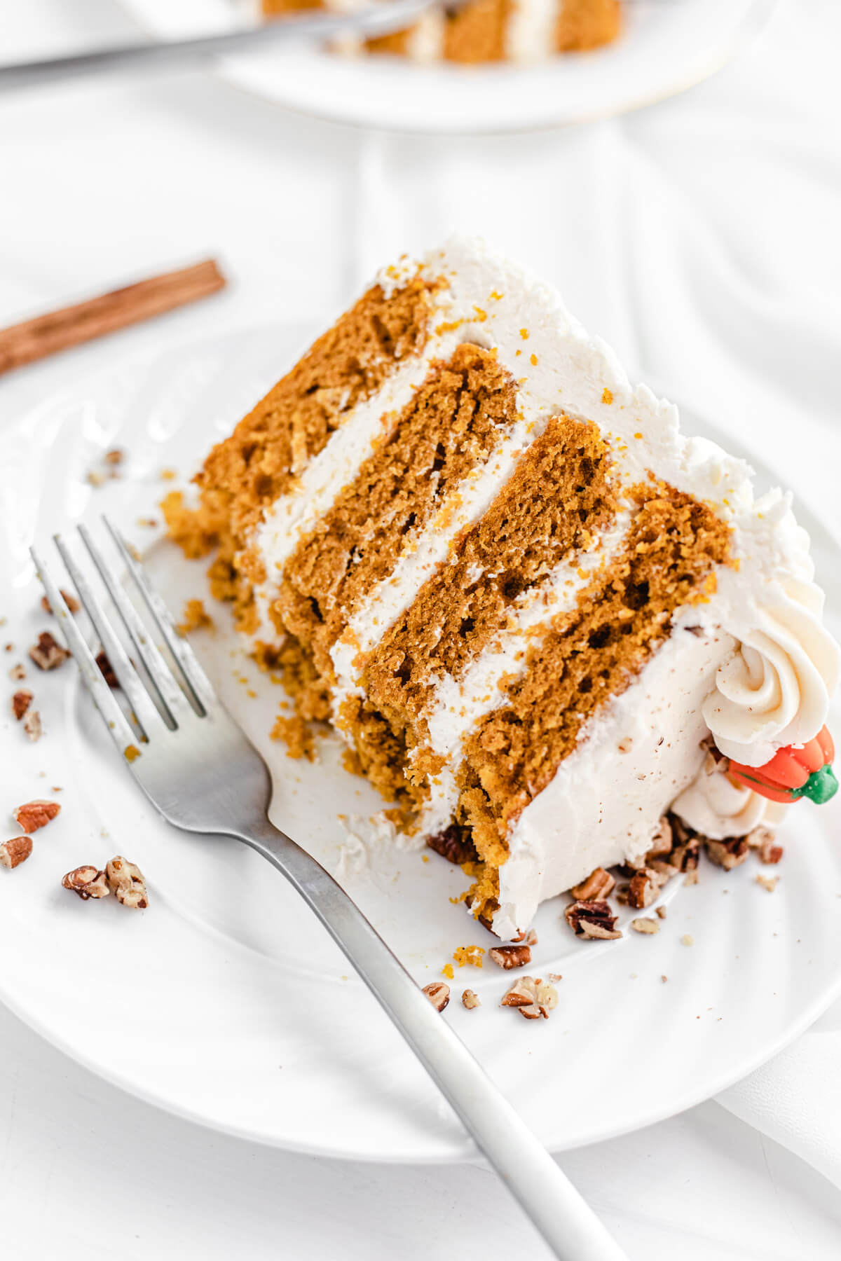 half eaten cake on a white plate with a fork