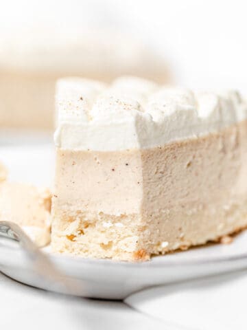 close up of eggnog cheesecake slice on a plate