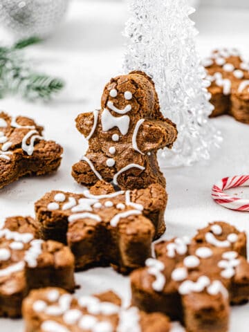 gingerbread man blondie propped up onto a clear glass Christmas tree