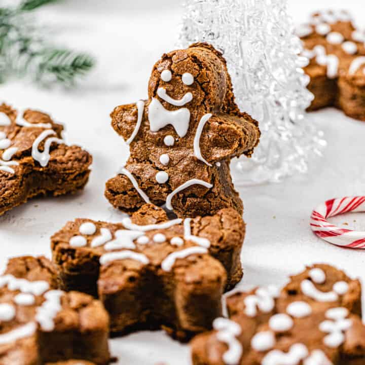 gingerbread man blondie propped up onto a clear glass Christmas tree