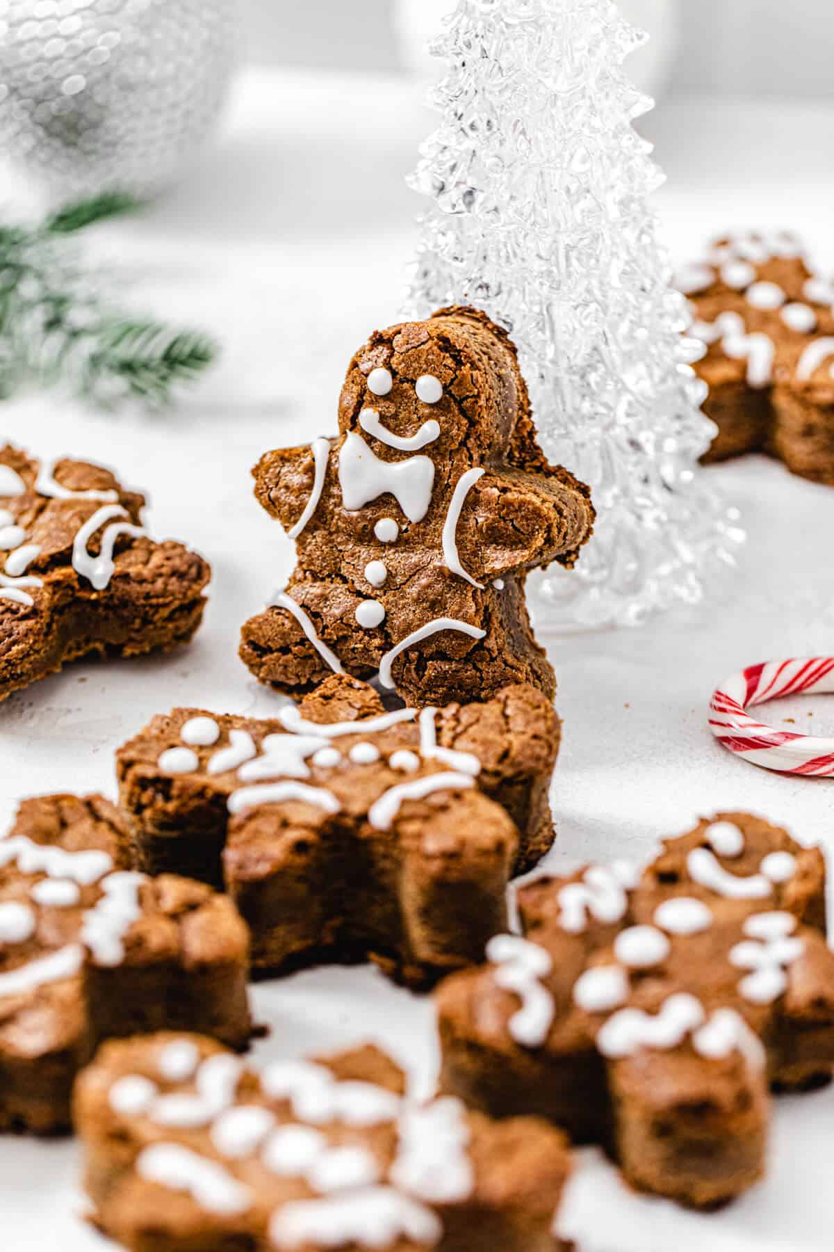 gingerbread man blondie propped up onto a clear glass Christmas tree