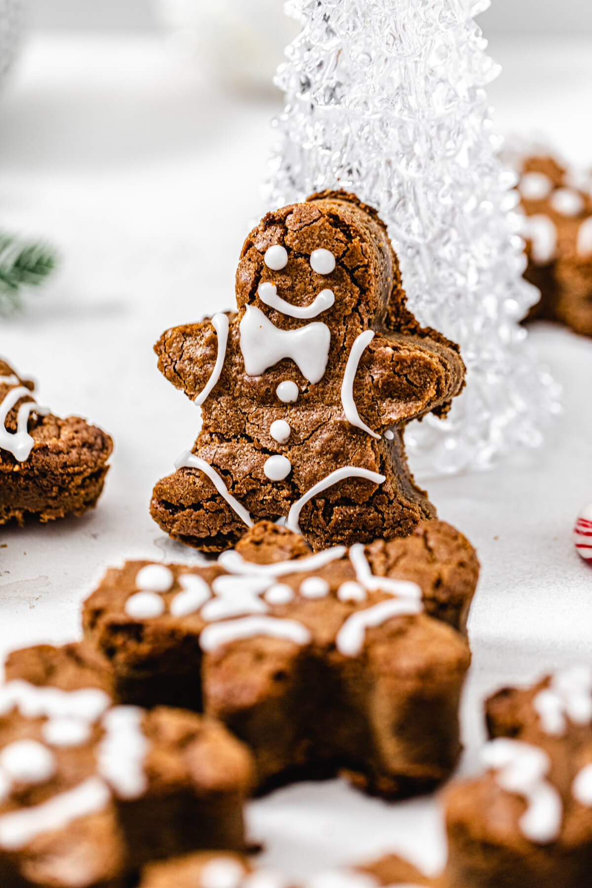 close up of gingerbread man propped onto glass Christmas tree