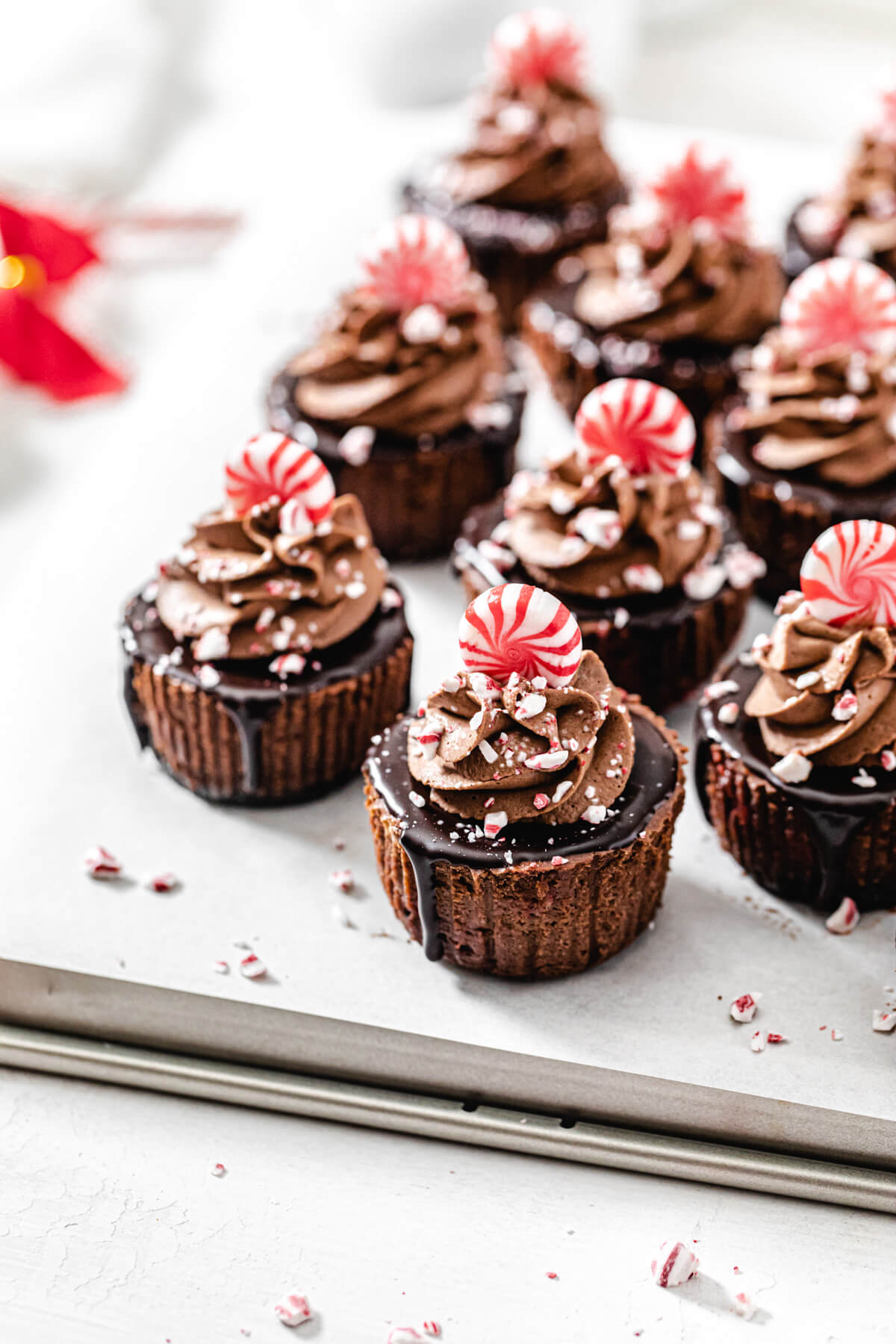 cheesecakes topped with peppermints on a baking sheet