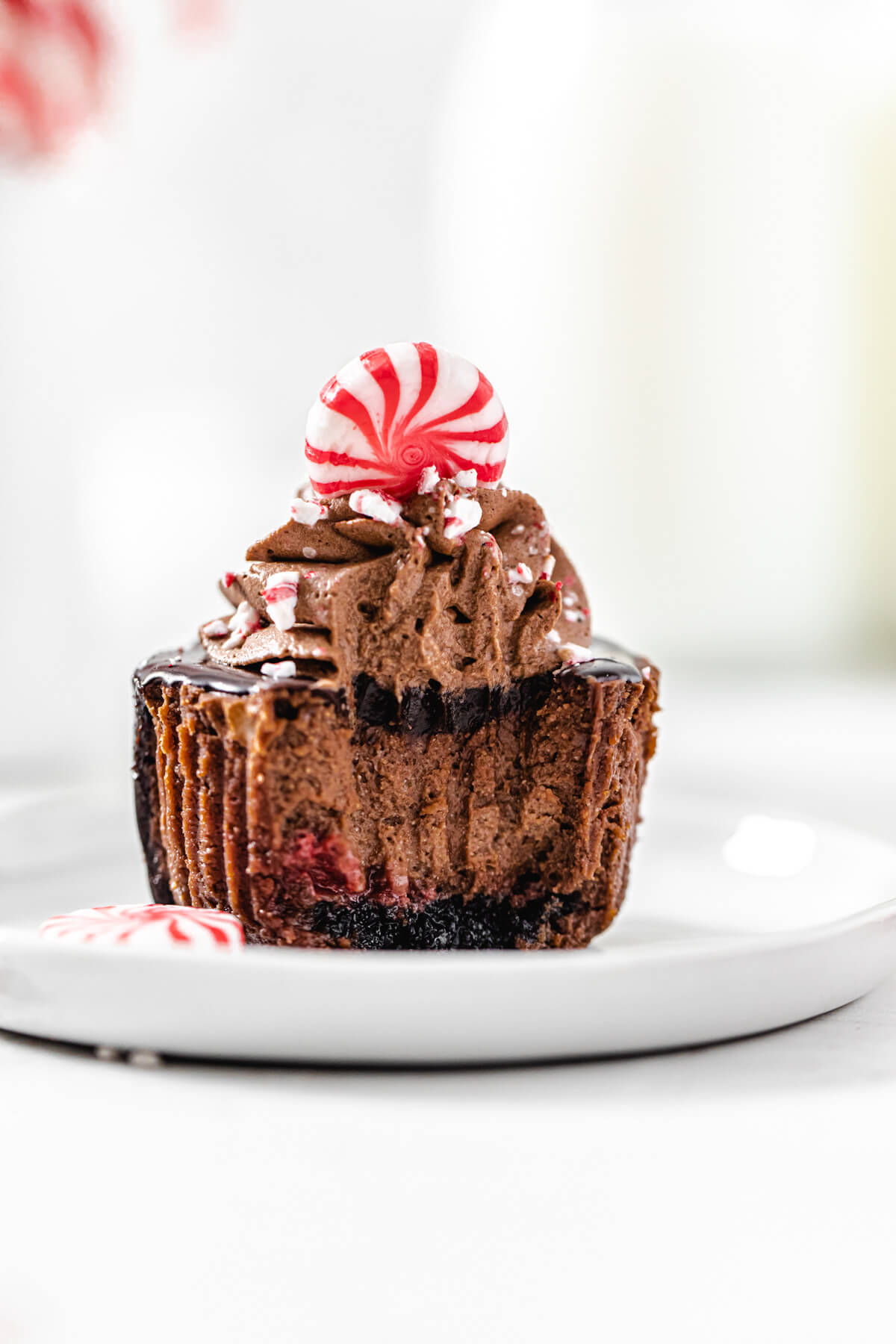 cheesecake cupcake on a small white plate with a bite taken out of it