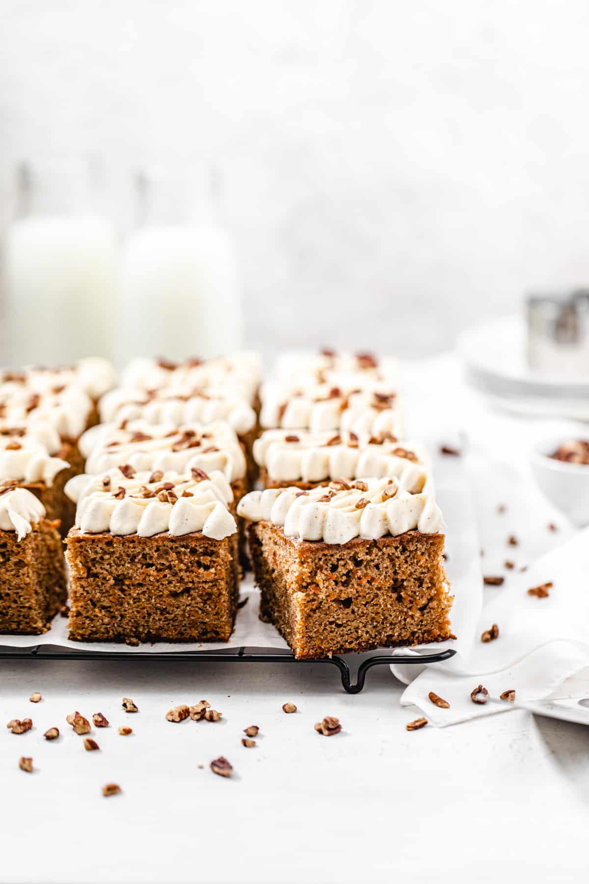 carrot cake slices on a parchment lined cooling rack