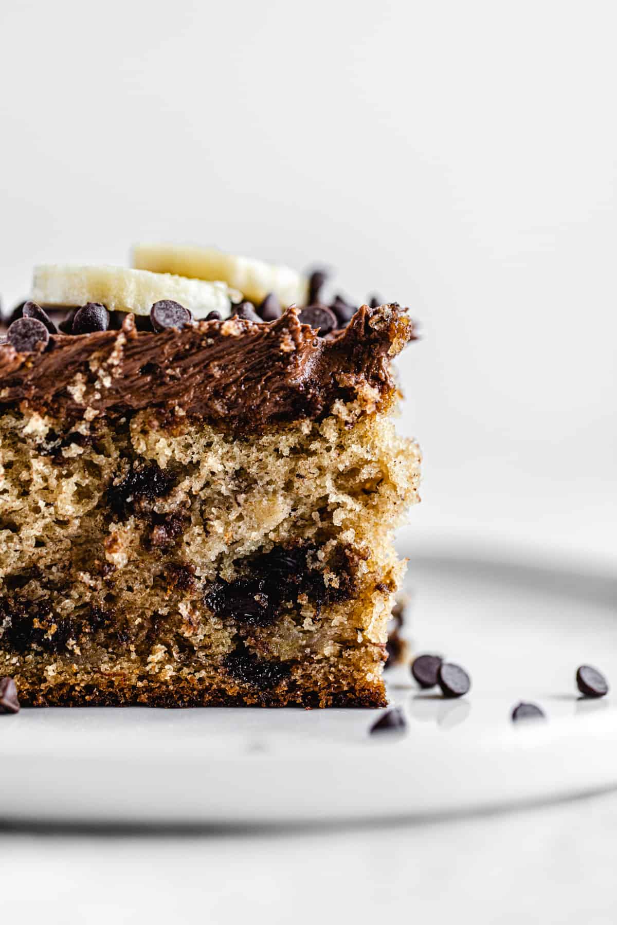 close up side shot of cake slice on a white plate