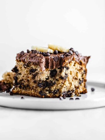 slice of cake on a white plate with bite taken out of it