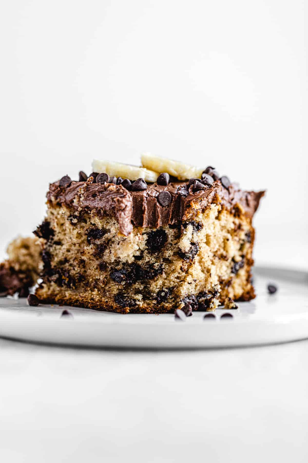 slice of cake on a white plate with bite taken out of it