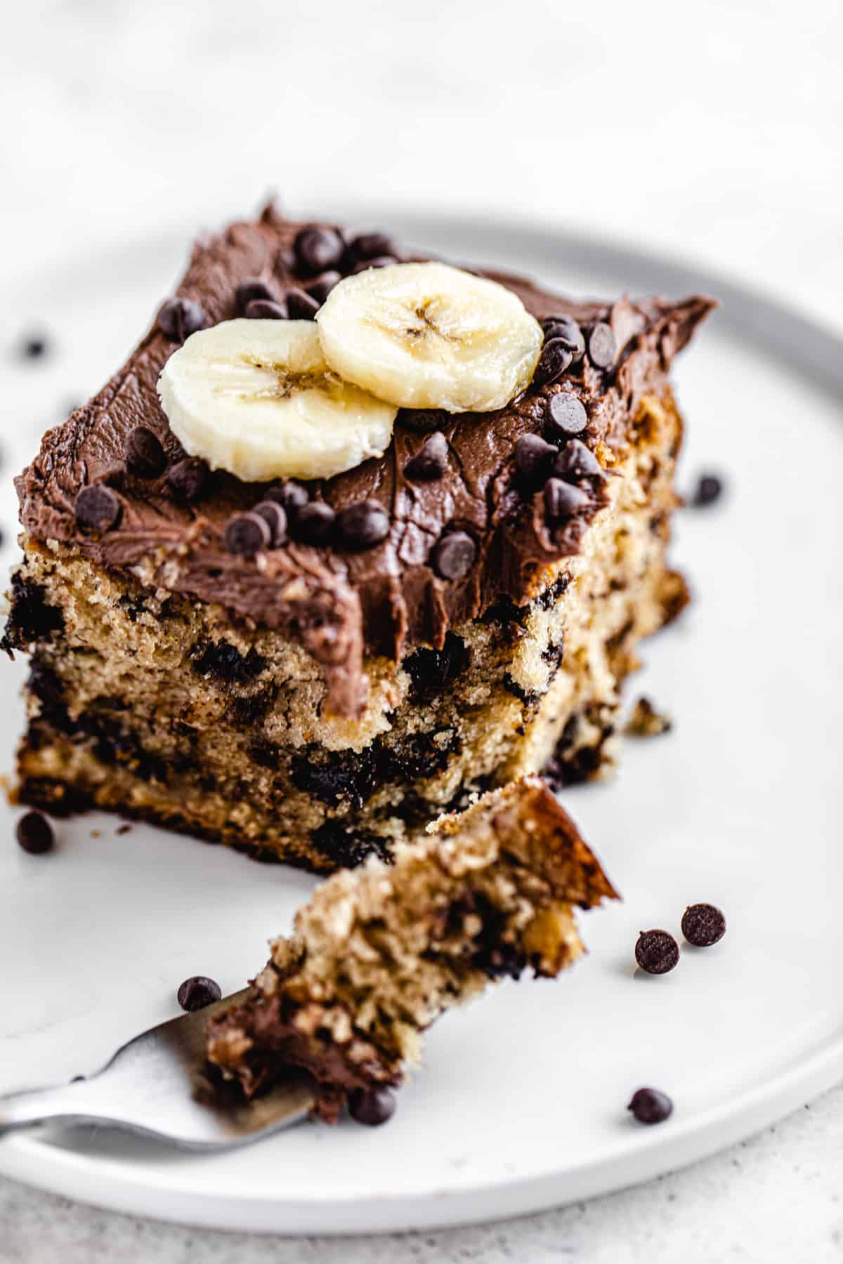 angled view of cake slice with a fork bite taken out of it