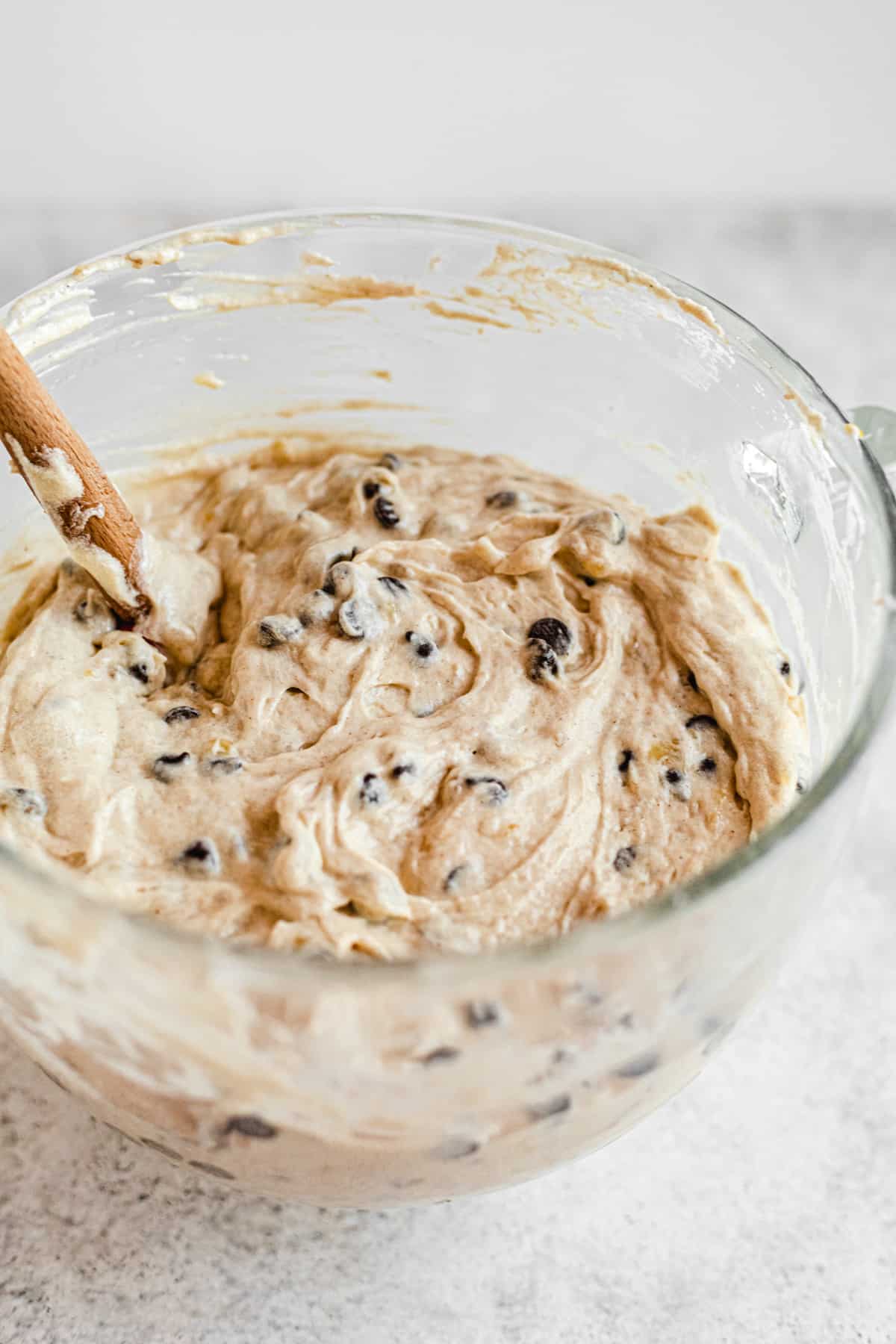 chocolate chip banana cake batter in a glass mixing bowl