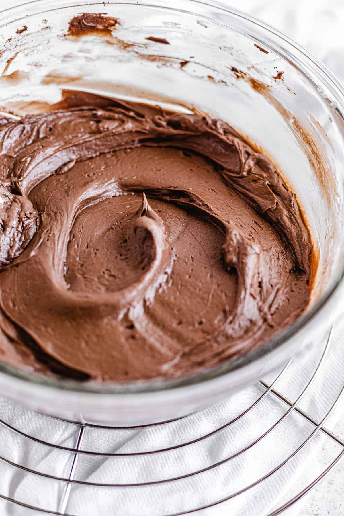 chocolate frosting in a glass mixing bowl