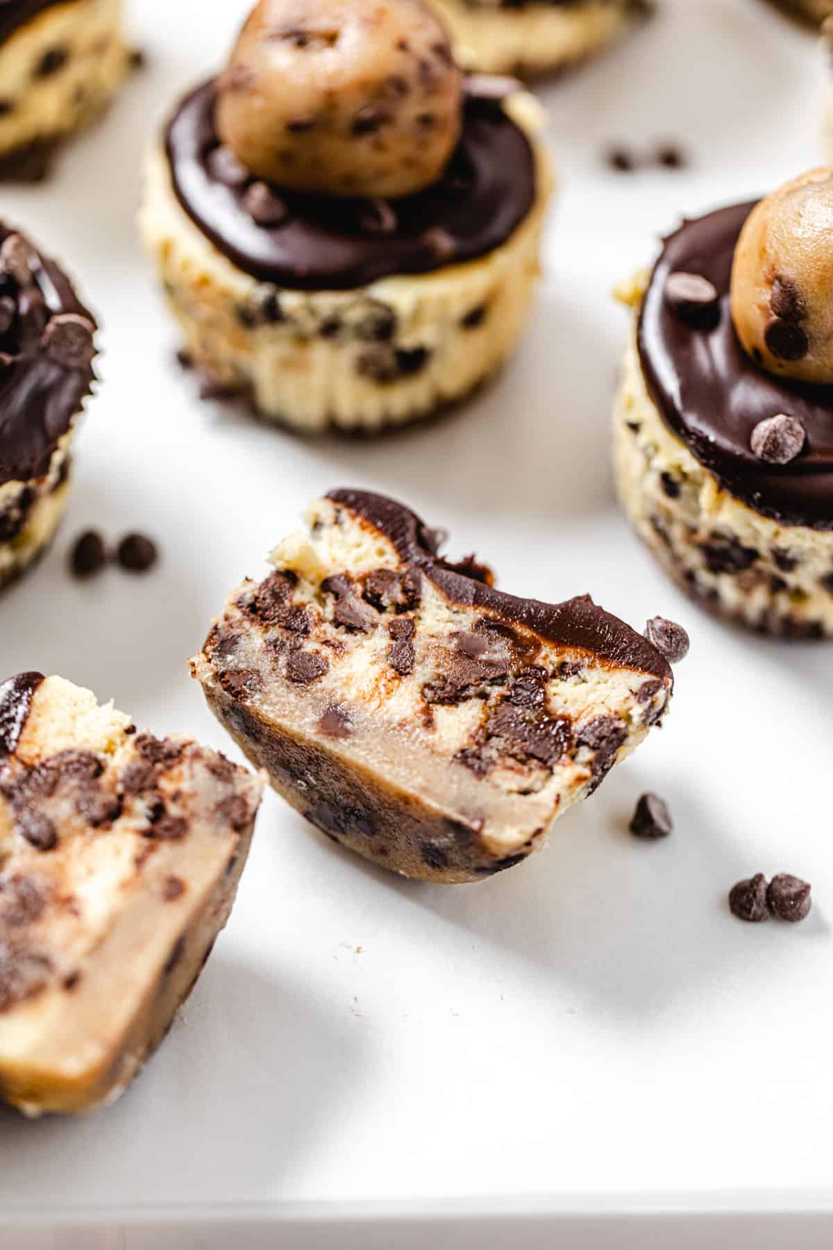 close up angled view of halved cheesecakes with a cookie dough bottom