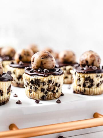 mini cheesecakes on the back of a white tray