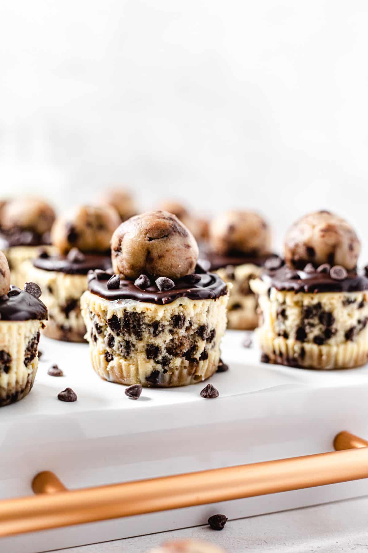 mini cheesecakes on the back of a white tray