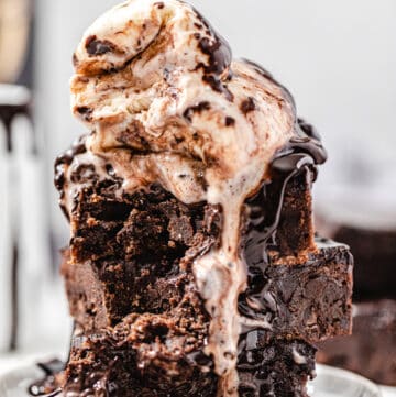 stack of brownies topped with two scoops of vanilla ice cream